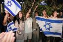 Israelis cheer as a helicopter carrying released hostages lands in Tel Aviv