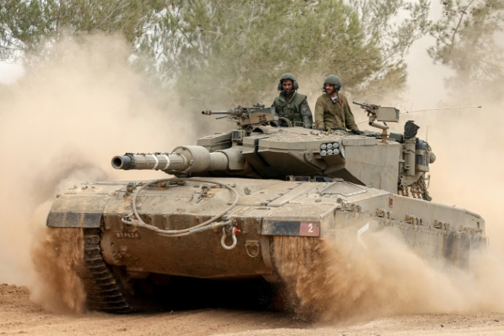 An Israeli tank rolls near the border with the Gaza Strip on December 5, 2023