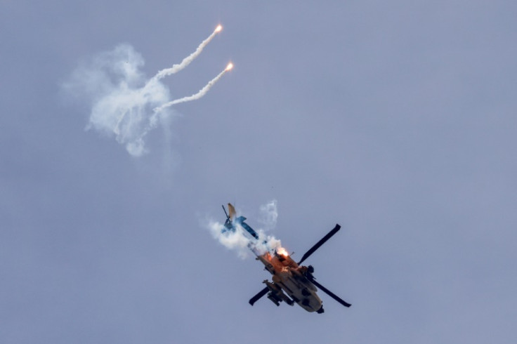 An Israeli helicopter fires flares as it flies over the Gaza Strip on December 7, 2023
