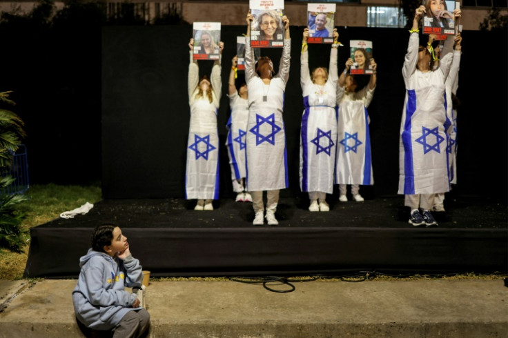 Demonstrators hold portraits of hostages calling for their release outside the Tel Aviv Museum of Art