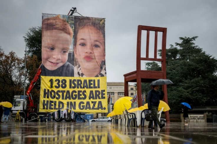 A banner highlights the plight of hostages held by Hamas in Gaza, outside the United Nations Offices in Geneva on December 12, 2023
