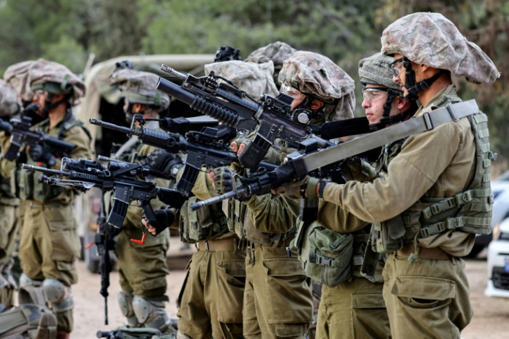 Israeli soldiers gather in the Gaza border area in southern Israel on December 12, 2023 amid ongoing battles with the Palestinian Hamas movement