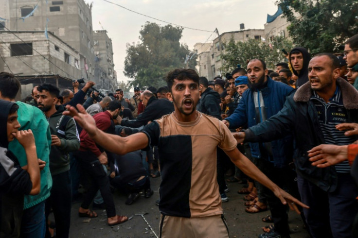 Palestinians gather after Israeli bombardment in Rafah, in the southern Gaza Strip on December 12, 2023