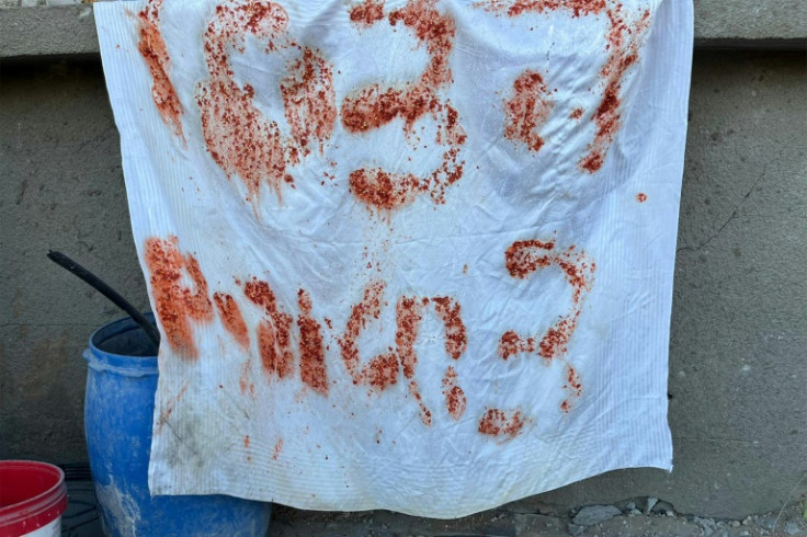 A picture released by the Israeli army shows a makeshift sign reading in Hebrew 'Help, 3 hostages', written using leftover food by Israeli hostages who were mistakenly killed by Israeli forces