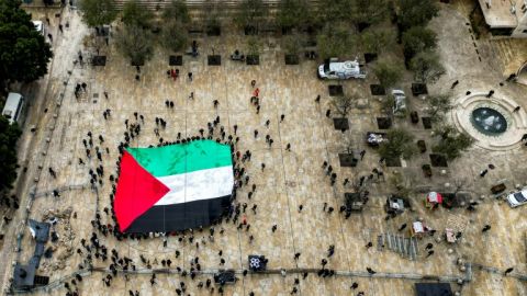 A giant Palestinian flag is unfurled outside the Church of the Nativity in the biblical city of Bethlehem in the occupied West Bank on Christmas Eve