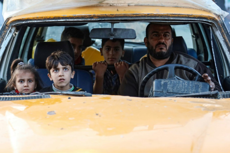 Residents of the refugee camp of Bureij arrive in Deir al-Balah in the central Gaza Strip following an evacuation order