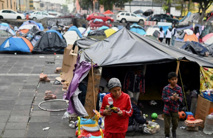 Children play at a makeshift migrant camp in the Tlahuac area of Mexico City