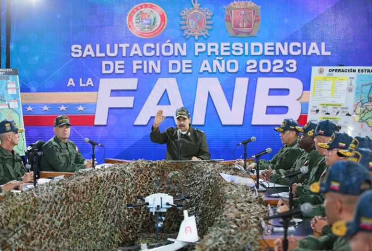 A handout picture by Venezuela's government shows President Nicolas Maduro (C) delivering a speech in Caracas before members of the country's armed forces on December 28, 2023
