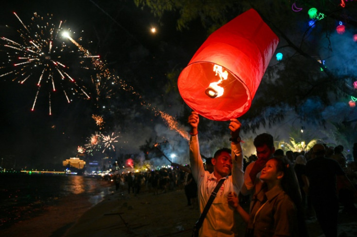 Lanterns with fire cast aloft at New Year celebrations in Sihanoukville, Cambodia