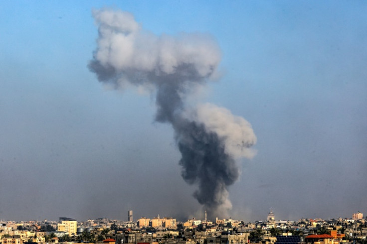 A picture taken from Rafah on January 6, 2024 shows smoke billowing over Khan Yunis in the southern Gaza Strip