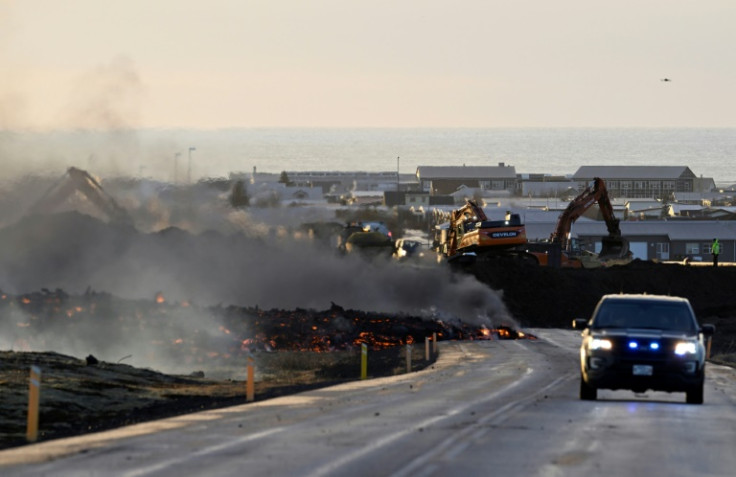 Emergency workers are filling a hole in the protective wall to prevent lava flowing into Grindavik