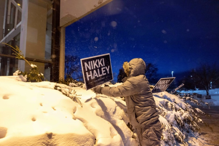 A campaign staffer places signs supporting former UN ambassador and 2024 presidential hopeful Nikki Haley in Des Moines, Iowa, on January 15, 2024, the day of the Iowa caucuses, the first statewide vote in the US presidential nominations race