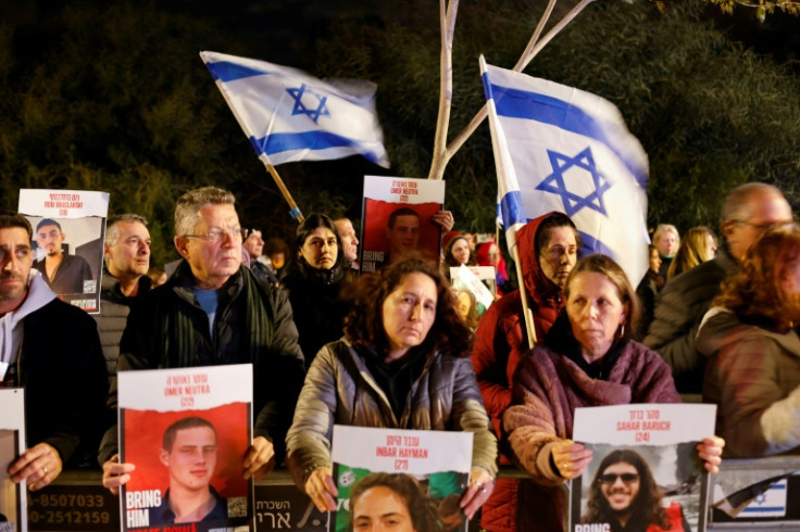 Protesters hold portraits of Israelis held hostage by Palestinian Hamas militants in Gaza since October 7, during a rally demanding their release outside Israeli Prime Minister Benjamin Netanyahu's private residence north of Tel Aviv