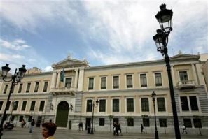 People walk outside central building of National Bank of Greece in Athens