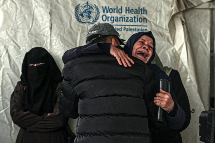 Palestinians mourn after identifying the bodies of relatives at Al-Najjar hospital in Rafah