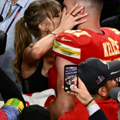 The presence of US pop icon Taylor Swift, seen here kissing her partner Travis Kelce after his Kansas City Chiefs won the Super Bowl, may have boosted viewership of the NFL championship game to a record level