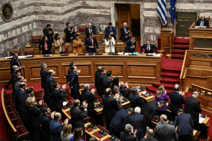Members of the Greek government applauded Greek Prime Minister Kyriakos Mitsotakis after his speech