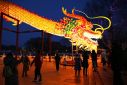 People gather to look at a giant dragon figure at a park in Beijing on February 9, 2024, which marks the eve of the Lunar New Year of the Dragon.