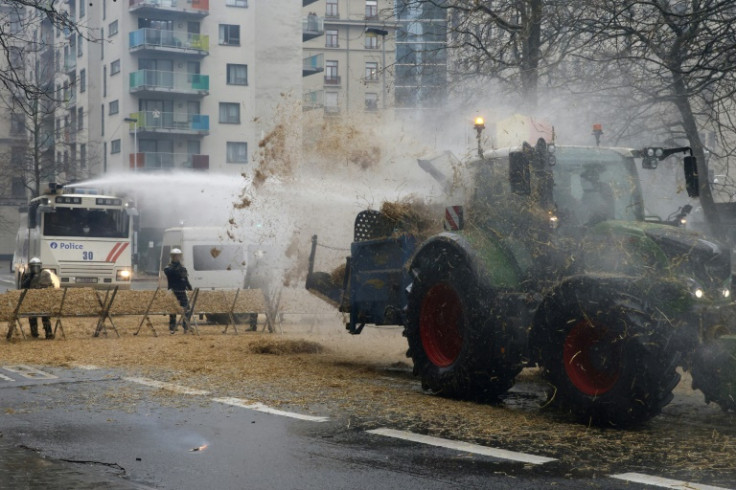 A tractor discharged hay onto riot police in Brussels
