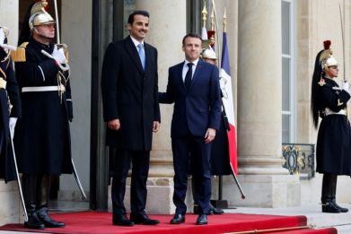 French President Emmanuel Macron greets Qatar's Emir Sheikh Tamim bin Hamad al-Thani at the Elysee Palace before talks dominated by the Gaza war
