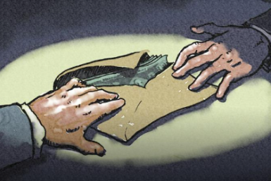 Hands exchanging an envelope filled with money