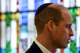 Prince William wears a kippah during a visit to the Western Marble Arch Synagoguein London