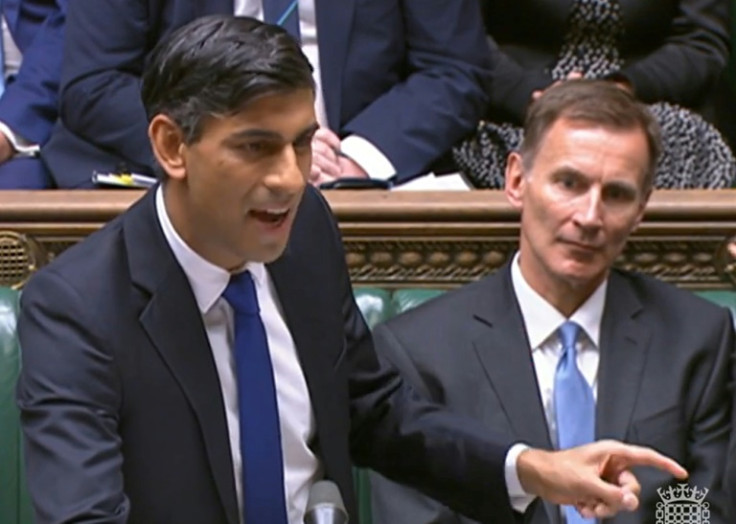 Finance minister Jeremy Hunt (R) has dampened hopes of tax cuts as Prime Minister Rishi Sunak's (L) Conservatives trail in opinion polls