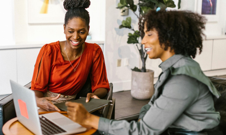 2 office women smiling