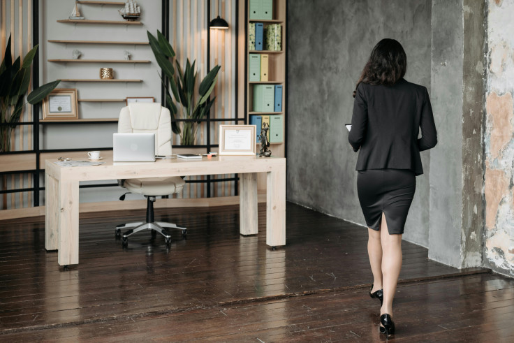 Woman walking away in office