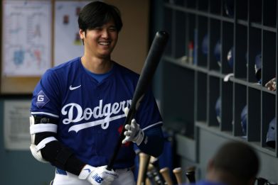 Los Angeles Dodgers superstar Shohei Ohtani of Japan smiles as he warms up for an exhibition game against the Los Angeles Angels at Dodger Stadium