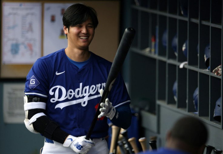 Los Angeles Dodgers superstar Shohei Ohtani of Japan smiles as he warms up for an exhibition game against the Los Angeles Angels at Dodger Stadium