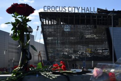 Flowers lie outside the burnt-out Crocus City Hall concert venue in Krasnogorsk, outside Moscow