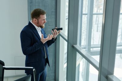 Man in Blue Suit Jacket Holding Black Smartphone