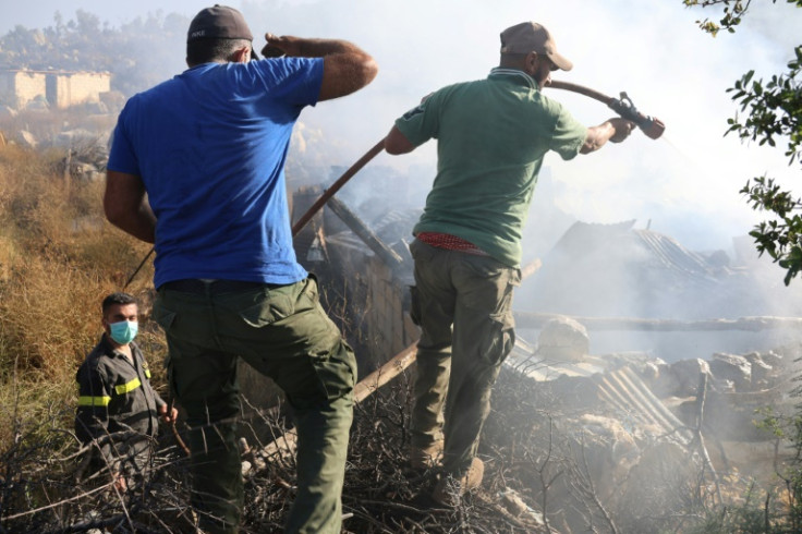 Lebanese firefighters tackle a blaze sparked by Israeli shelling of the border village of Shebaa