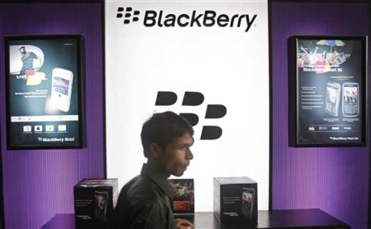 A boy stands in front of a Blackberry counter at a mobile showroom in New Delhi