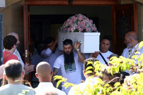 Pallbearers carry the coffin of nine-year-old Alice da Silva Aguiar