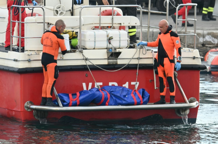 Divers bring a body back from the luxury yacht Bayesian after it sank killing seven people