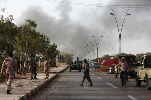 Anti-Gaddafi fighters stand guard at an area that they have taken control as their forces capture main landmarks in Sirte