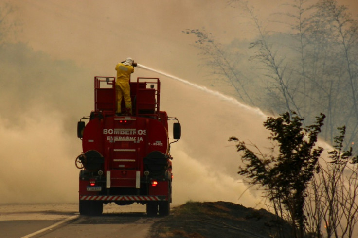 Firefighters battle a blaze in Sao Paulo state - smoke from these fires has drifted hundreds of kilometers to Brasilia