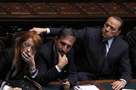 Italy's Prime Minister Berlusconi attends near Italy's Tourism Minister Brambilla and Defence Minister La Russa during a debate at the lower house of parliament in Rome