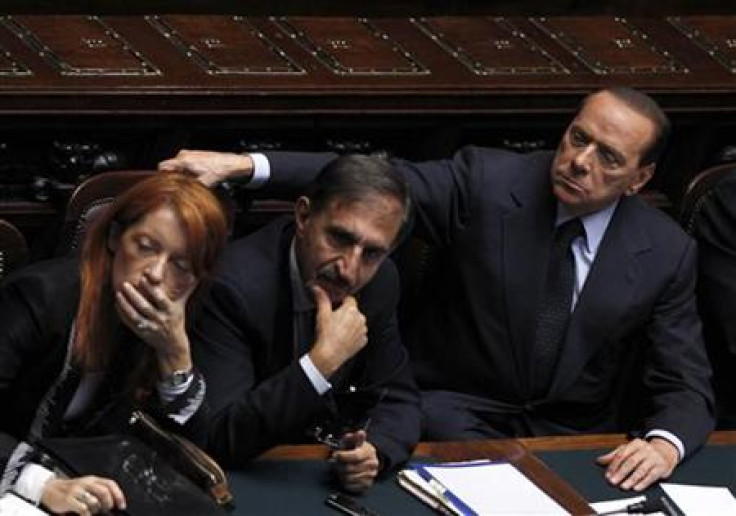 Italy's Prime Minister Berlusconi attends near Italy's Tourism Minister Brambilla and Defence Minister La Russa during a debate at the lower house of parliament in Rome