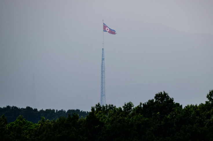 A North Korean flag seen from Paju in South Korea flutters over the village of Gijungdong in July 2024