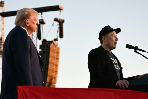 Elon Musk speaks on stage as he joins Donald Trump during a campaign rally
