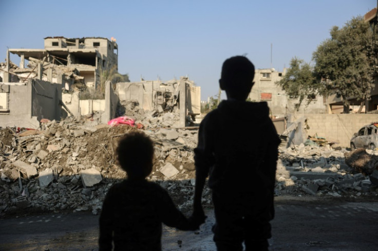 Gazan children stare at destruction from an Israeli strike on Nuseirat refugee camp