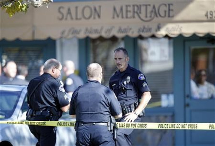 Police officers guard the entrance to Salon Meritage following a shooting that left six people dead and three injured in Seal Beach, California