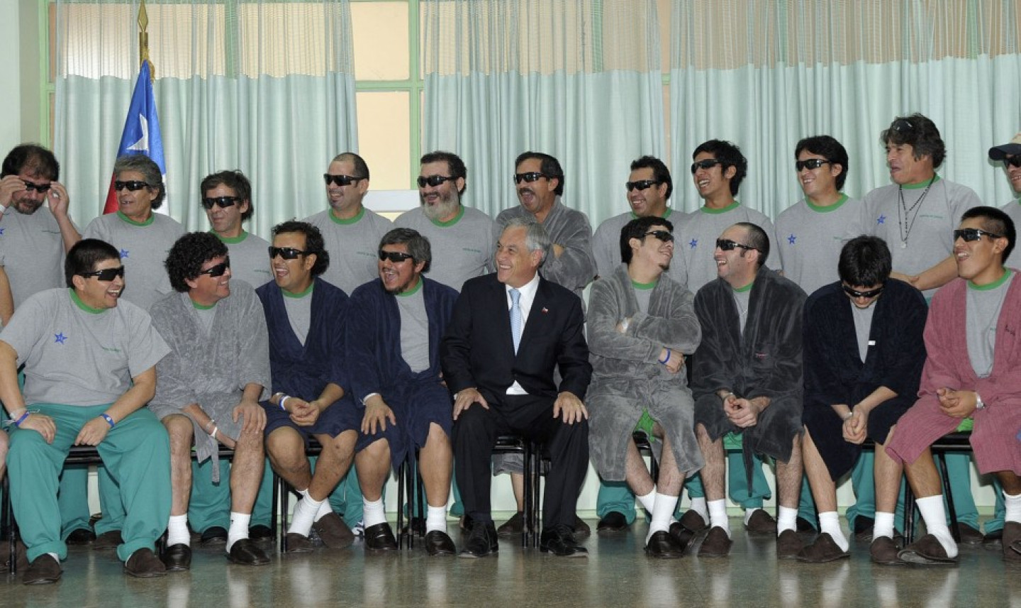 Chile's President Pinera poses with the 33 rescued miners inside Copiapo Hospital