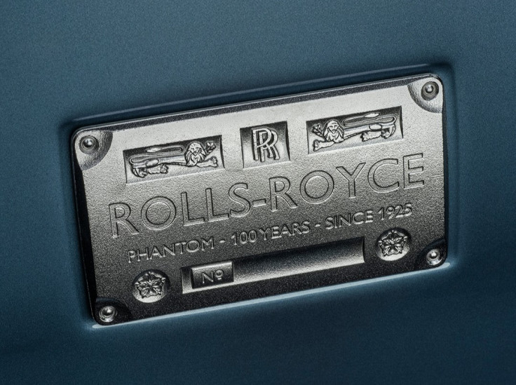 Close-up of the Rolls-Royce iron plate logo on a car's