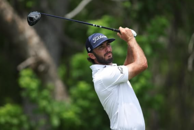 Max Homa holding a golf club