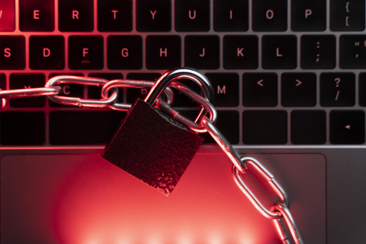 Locked laptop with red alert symbolising breach vulnerability risk