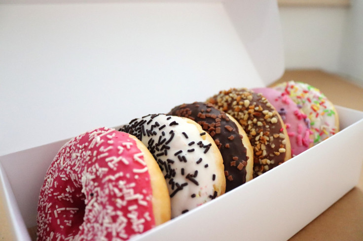 Box of doughnuts glazed with sprinkles